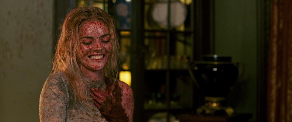 Grace (Samara Weaving) gets covered in blood and guts but still manages a grin in "Ready or Not."