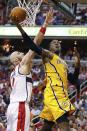 Indiana Pacers center Roy Hibbert (55) shoots under pressure form Washington Wizards center Marcin Gortat of Poland during the second half of Game 3 of an Eastern Conference semifinal NBA basketball playoff game in Washington, Friday, May 9, 2014. (AP Photo/Alex Brandon)