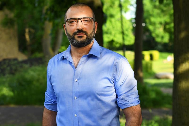 Human rights lawyer Mazen Masri poses for a portrait outside his house in north London