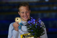 Justin Ress of the United States listens to his national anthem after winning the men's 50m backstroke final at the 19th FINA World Championships in Budapest, Hungary, Saturday, June 25, 2022. (AP Photo/Petr David Josek)