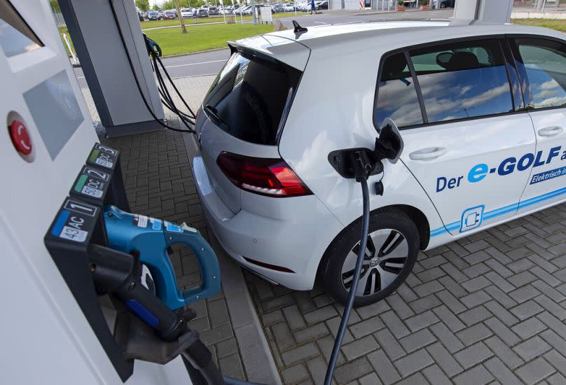 An electric car is charged at a charging station.