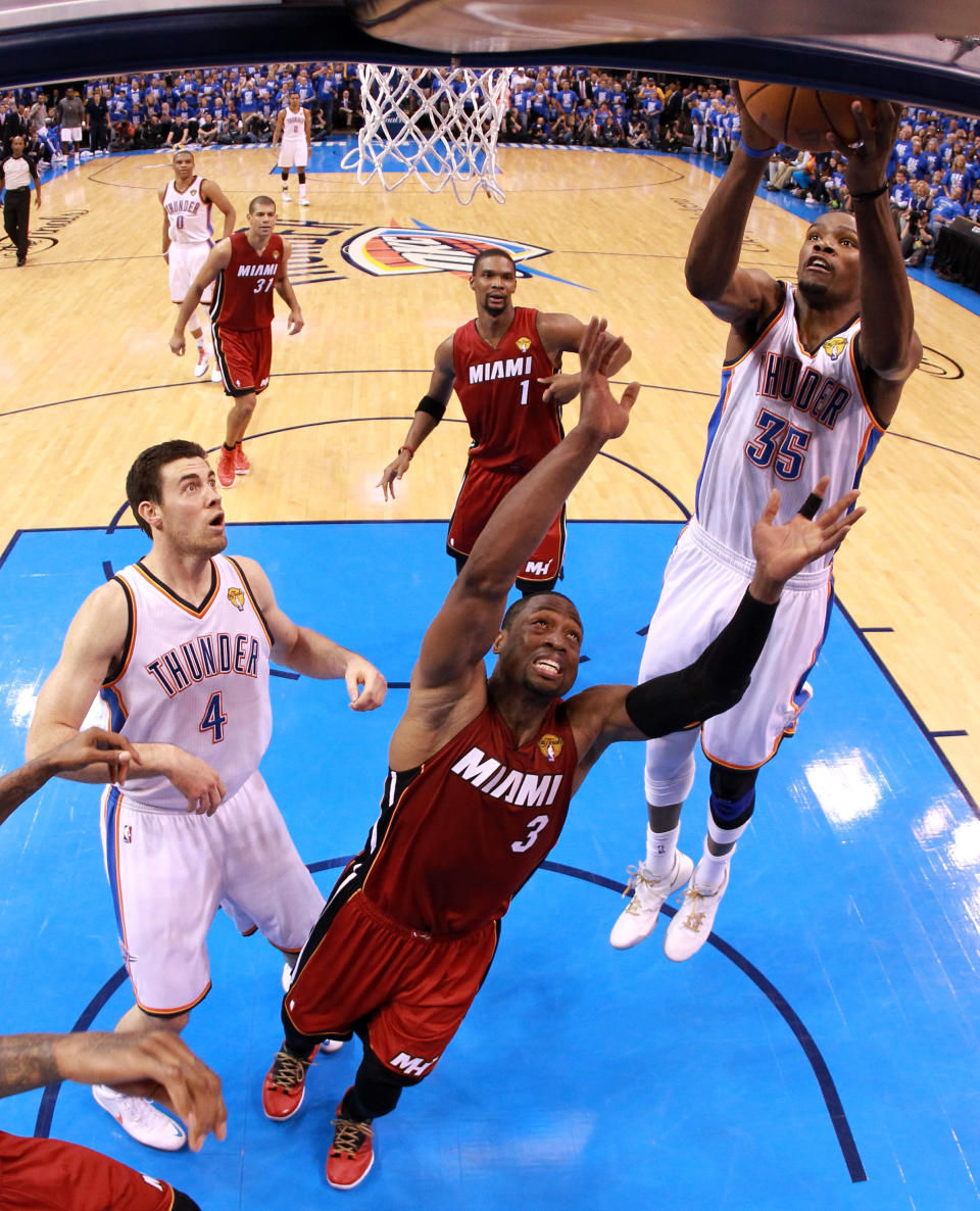 Kevin Durant of the Oklahoma City Thunder goes up for a layup over Dwyane Wade of the Miami Heat in the second half in Game One of the 2012 NBA Finals at Chesapeake Energy Arena on June 12, 2012 in Oklahoma City, Oklahoma. (Photo by Ronald Martinez/Getty Images)