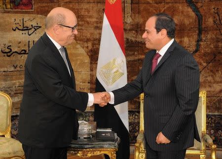 FILE PHOTO: Egyptian President Abdel Fattah al-Sisi (R) shakes hands with then French Defence Minister Jean-Yves Le Drian at the Ittihadiya presidential palace in Cairo, Egypt February 28, 2017 in this handout picture courtesy of the Egyptian Presidency. The Egyptian Presidency/Handout via REUTERS