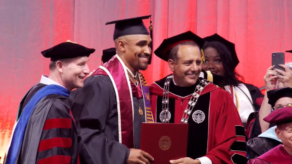 jalen hurts in graduation cap and gown at University of Oklahoma commencement ceremony