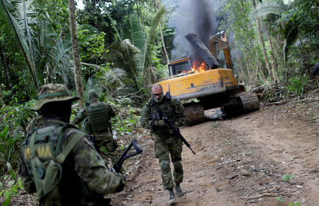 Machines are destroyed at an illegal cassiterite mine during an operation conducted by agents of the Brazilian Institute for the Environment and Renewable Natural Resources, or Ibama, in national parks near Novo Progresso, southeast of Para state, Brazil, November 4, 2018. REUTERS/Ricardo Moraes