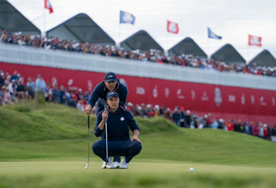 Brooks Koepka and Jordan Speith read a putt at the 2021 Ryder Cup at Whistling Straights.<p>Courtesy of Rolex</p>