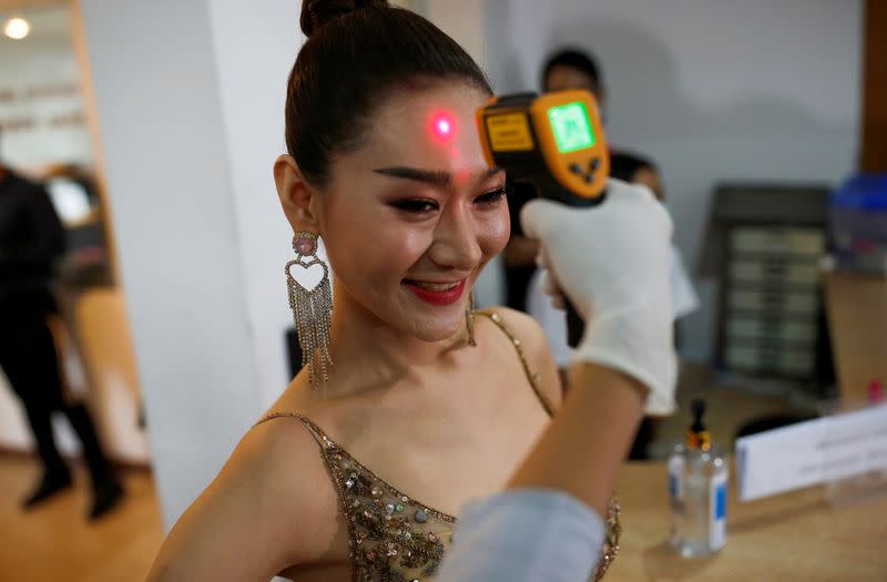 Lacey of China has her temperature checked before the final show of the Miss International Queen 2020 transgender beauty pageant in Pattaya