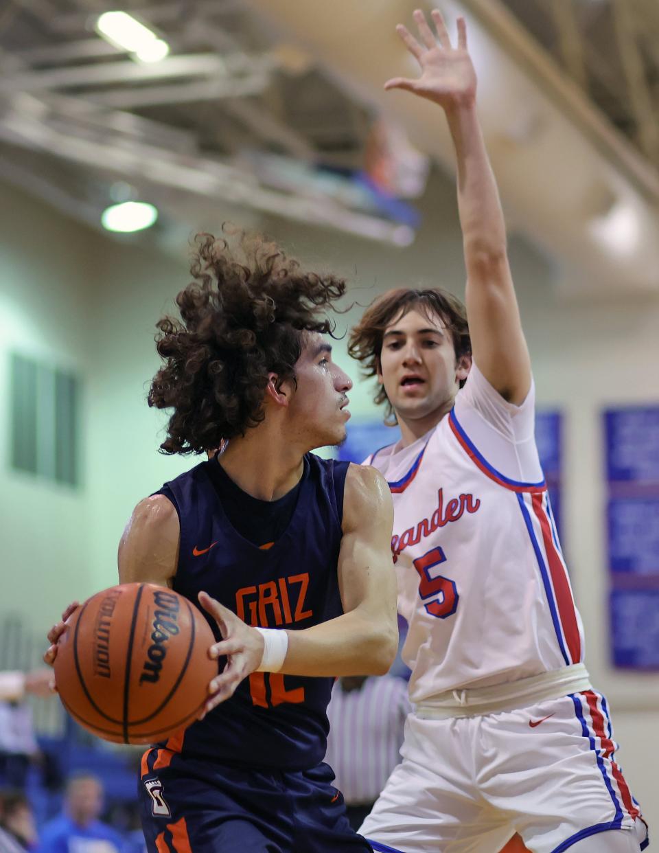 Glenn guard Omar Perez, left, looks to pass the ball around the defense of Leander's Hayden Lucas. The win gave the Lions a regular-season series sweep over Glenn.