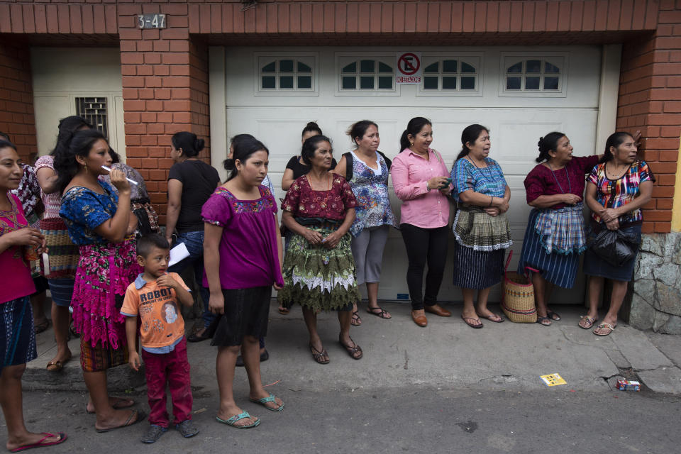 In this Wednesday, June 12, 2019, photo, women observe from afar a rally of Thelma Cabrera, presidential candidate of the Movement for the Liberation of the People, MLP, in Palin, Guatemala. (AP Photo/Moises Castillo)