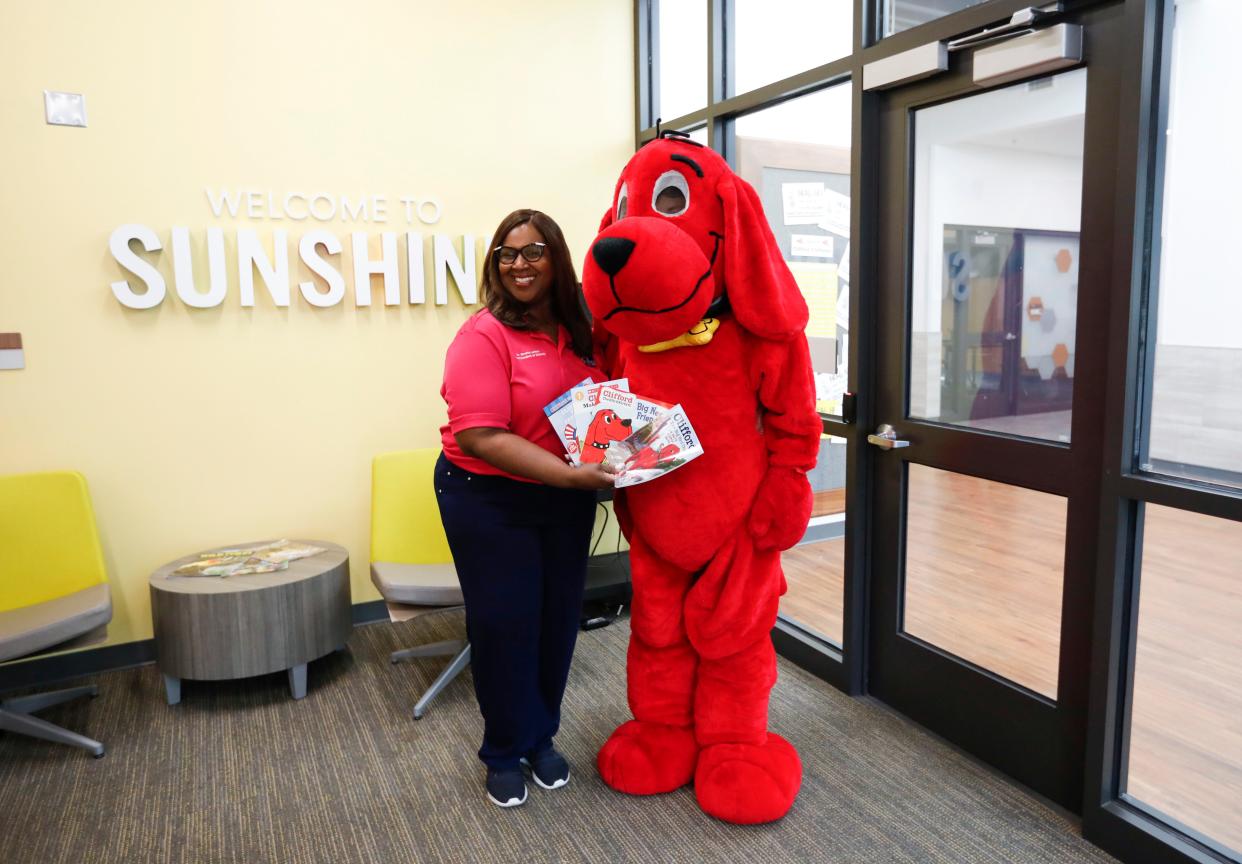 Superintendent Grenita Lathan poses with Clifford the Big Red Dog during a July 8 visit to Sunshine Elementary. His visit is part of a literacy push she has prioritized for the summer and fall.