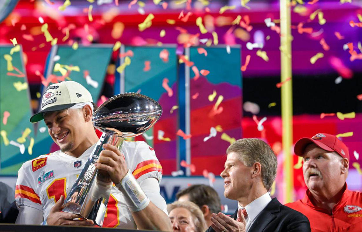 Kansas City Chiefs quarterback Patrick Mahomes (15) hoists the Lombardi Trophy after leading the Chiefs to a Super Bowl LVII victory, 38-35, over the Philadelphia Eagles on Sunday, Feb. 12, 2023, at State Farm Stadium in Glendale, Arizona. Chiefs Chairman & CEO Clark Hunt and head coach Andy Reid look on. (Tammy Ljungblad/The Kansas City Star/Tribune News Service via Getty Images)