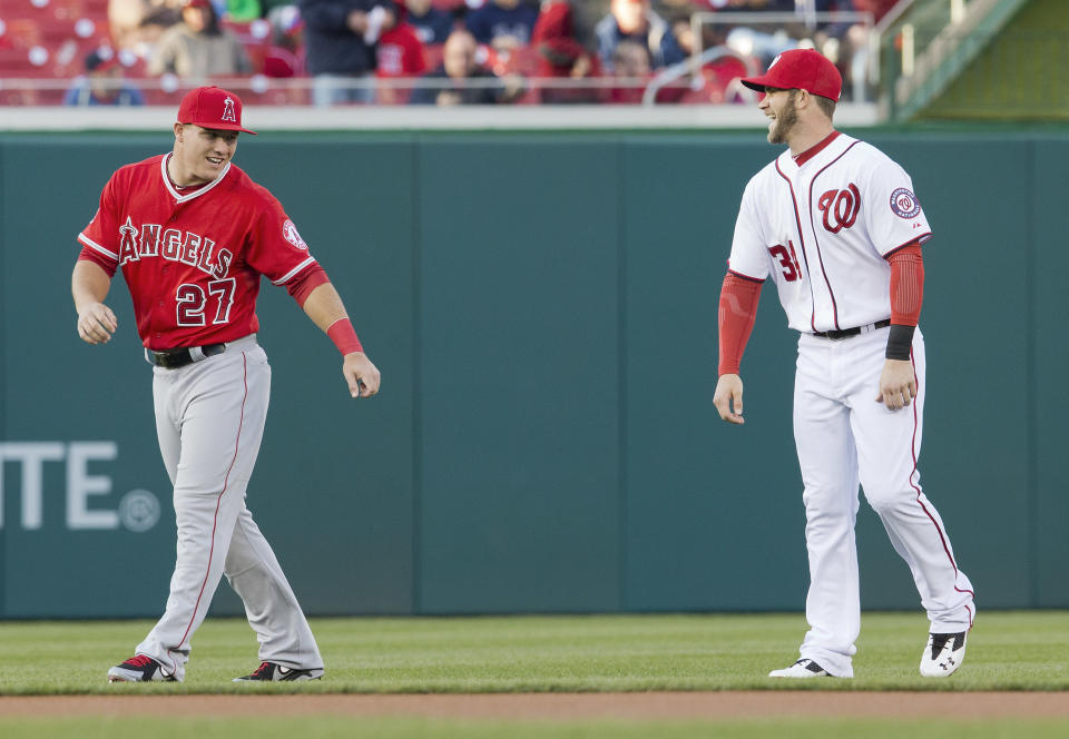 Los Angeles Angels Mike Trout, left, and Washington Nationals Bryce Harper, right, during warm ups before the start of their baseball game, Wednesday, April 23, 2014 in Washington. (AP Photo/Pablo Martinez Monsivais)