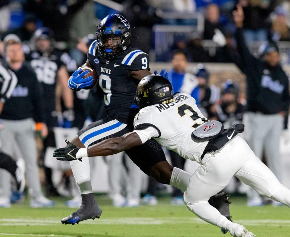 Duke’s Jaquez Moore runs the ball past Wake Forest’s Malik Mustapha during the first half of the Blue Devils’ game on Thursday, Nov. 2, 2023, at Wallace Wade Stadium in Durham, N.C.