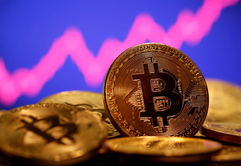 FILE PHOTO: FILE PHOTO: A representation of virtual currency Bitcoin is seen in front of a stock graph in this illustration taken