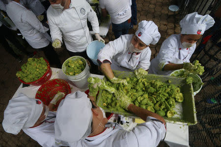 Volunteers from a culinary school mash avocados as they attempt to set a new Guinness World Record for the largest serving of guacamole in Concepcion de Buenos Aires, Jalisco, Mexico September 3, 2017. REUTERS/Fernando Carranza