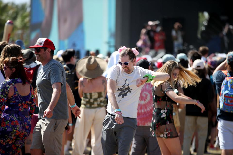 David Walton, center, of New Orleans dances Saturday during the Marc Rebillet performance at the Coachella Stage during the Coachella Valley Music and Arts Festival in Indio.