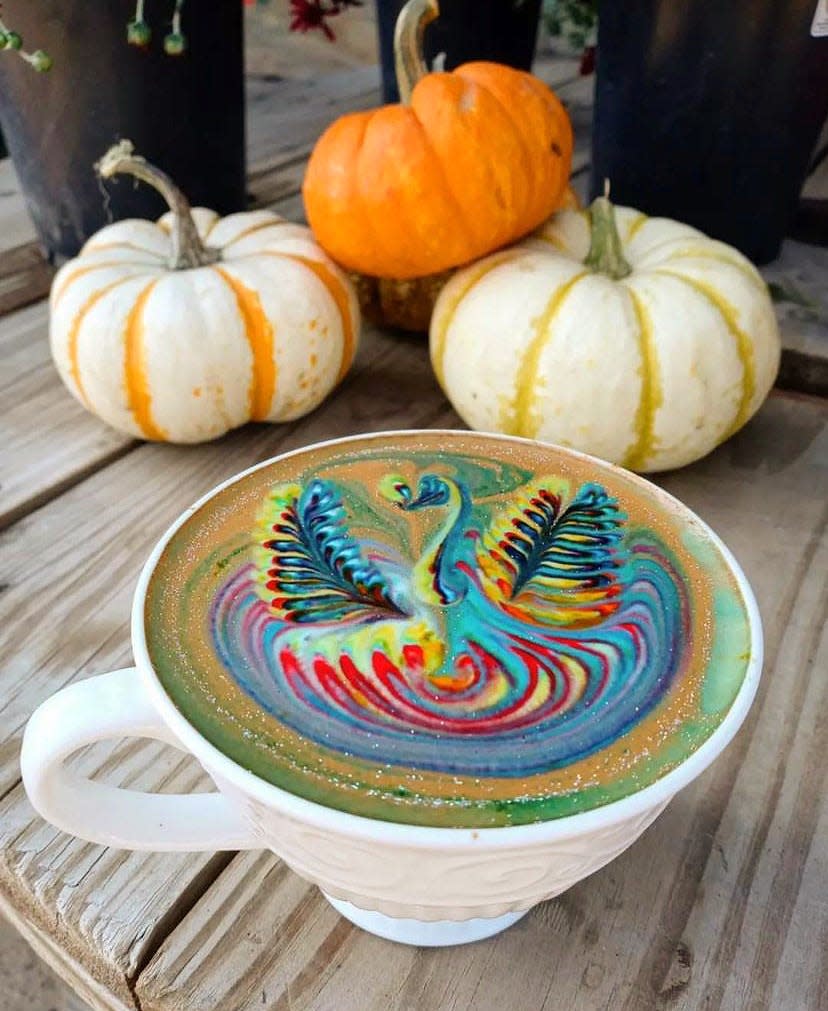 A spiced pumpkin latte from the Sacred Bean with edible glitter and latte art