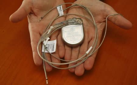 A doctor holds a mock-up of the world's first cardiac re-synchronisation therapy defibrillator device 'Consulta CRT-D', made by U.S. company Medtronic Inc. at the German Heart Institute Berlin (DHZB) in Berlin, April 29, 2008. REUTERS/Fabrizio Bensch