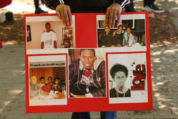 At a June 13, 2020 vigil and rally for Jamal Francique, family members displayed photos of him. Francique, 28, was shot in the back of the head while in his car during an attempted arrest on Jan. 7, 2020. He was put on life support and died in hospital two days later. (Michael Charles Cole/CBC - image credit)