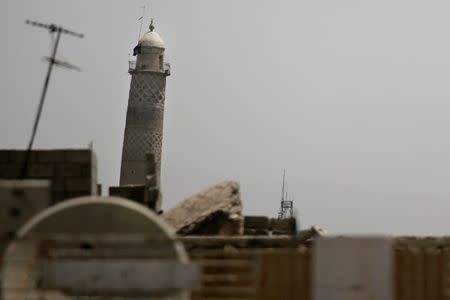 A black jihadist flag hangs from Mosul's Al-Habda minaret at the Grand Mosque, May 29, 2017. REUTERS/Alkis Konstantinidis