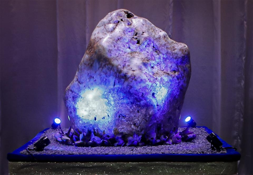 A 310 kilograms (683 pounds) heavy natural corundum blue sapphire is on display at a residence in Horana, about 41 kilometers (25 miles) south of Colombo, Sri Lanka, Sunday, Dec. 12, 2021. A gem company in Sri Lanka has unveiled the massive gemstone that is certified as a rare and one of the biggest corundums found in the country and plans to offer it to museums and gem collectors. (AP Photo/Eranga Jayawardena)