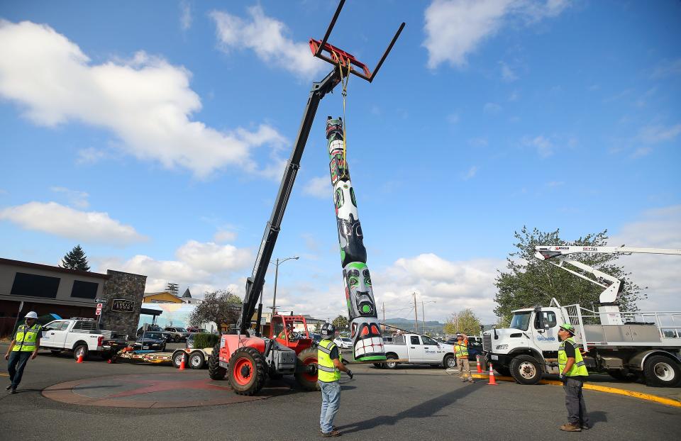 A Port Orchard Public Works crew moves the newly restored totem pole from a trailer to its position on the waterfront at the end of Sidney Ave. in Port Orchard on Wednesday, Aug. 30, 2023.