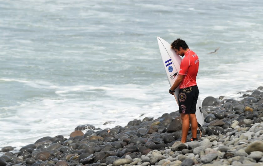 -SP-June 4, 2021: Surfer Bryan Perez prays before competing in the Surf City El Salvador ISA World Surfing Games. (Wally Skalij / Los Angeles Times)