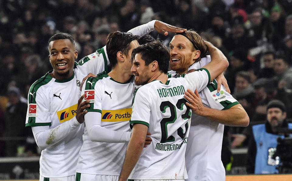 Moenchengladbach's Michael Lang, right, is celebrated after scoring his side's second goal during the German Bundesliga soccer match between Borussia Moenchengladbach and Hannover 96 at the Borussia Park in Moenchengladbach, Germany, Sunday, Nov. 25, 2018. (AP Photo/Martin Meissner)