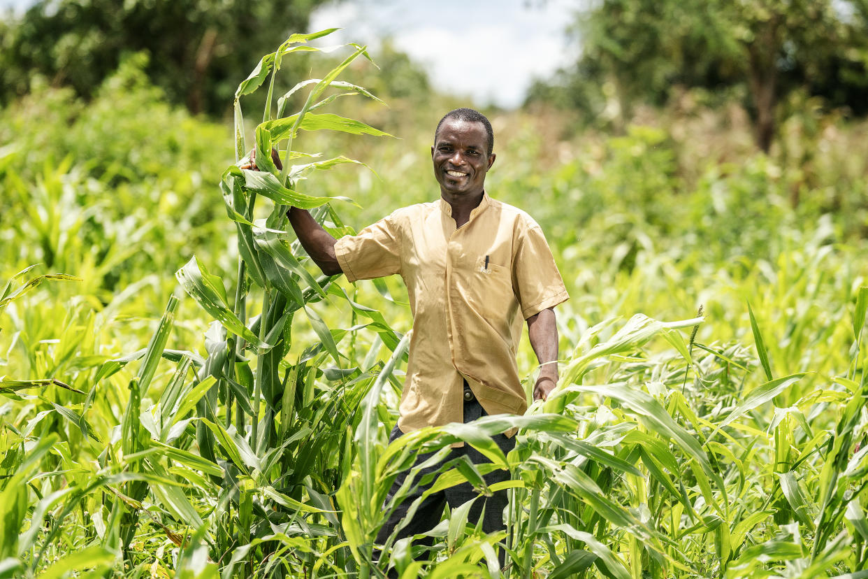 Farmer Simeon Kauinga, 40, with some of his maize crop in the Balaka district of Malawi (Brian Lawless/PA)