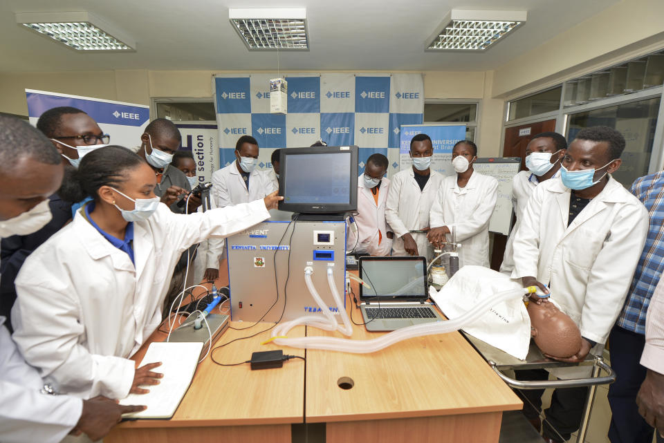 In this photo taken Monday, April 13, 2020, medical students test a self-designed computer-controlled ventilator prototype at the Chandaria Business and Incubation Centre of Kenyatta University in Nairobi, Kenya. Researchers across Africa are looking for ways to make their own ventilators, protective equipment and hand sanitizers as the continent faces a peak in coronavirus cases long after the United States and European countries have bought up global supplies during the pandemic. (AP Photo/John Muchucha)