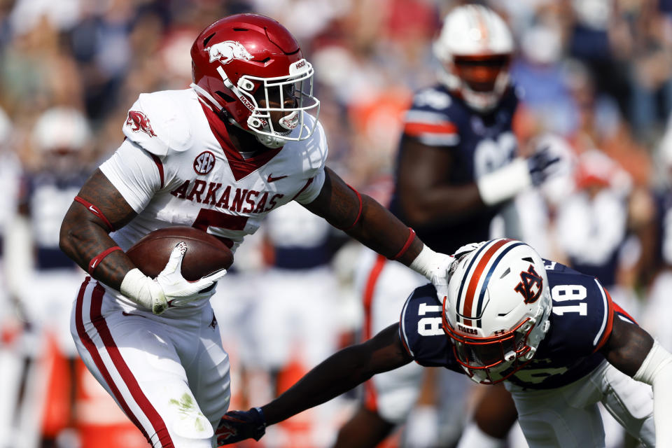 Arkansas running back Raheim Sanders (5) stiff arms Auburn cornerback Nehemiah Pritchett (18) as he carries the ball during the first half of an NCAA college football game Saturday, Oct. 29, 2022, in Auburn, Ala. (AP Photo/Butch Dill)