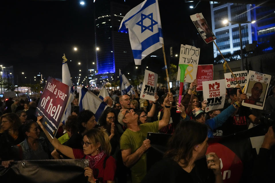 People take part in a protest against Israeli Prime Minister Benjamin Netanyahu's government and call for the release of hostages held in the Gaza Strip by the Hamas militant group in Tel Aviv, Israel, Saturday, April 6, 2024. (AP Photo/Ariel Schalit)