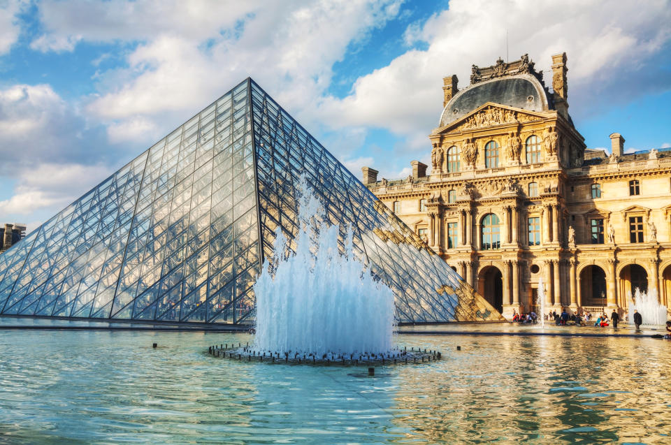 Paris, France - October 9, 2014: The Louvre Pyramid in Paris, France. It serves as the main entrance to the Louvre Museum. Completed in 1989 it has become a landmark of Paris.