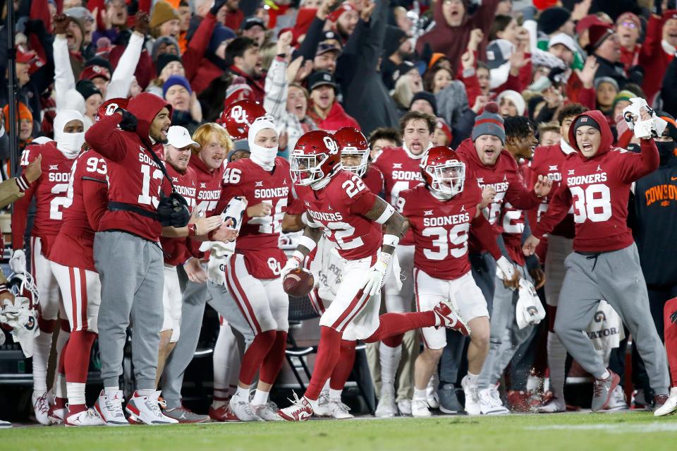 Nov 19, 2022; Norman, Oklahoma, USA; Oklahoma celebrates after Oklahoma's C.J. Coldon (22) intercepts a pass in the first quarter during the Bedlam college football game between the University of Oklahoma Sooners (OU) and the Oklahoma State University Cowboys (OSU) at Gaylord Family-Oklahoma Memorial Stadium. Mandatory Credit: Sarah Phipps-USA TODAY Sports