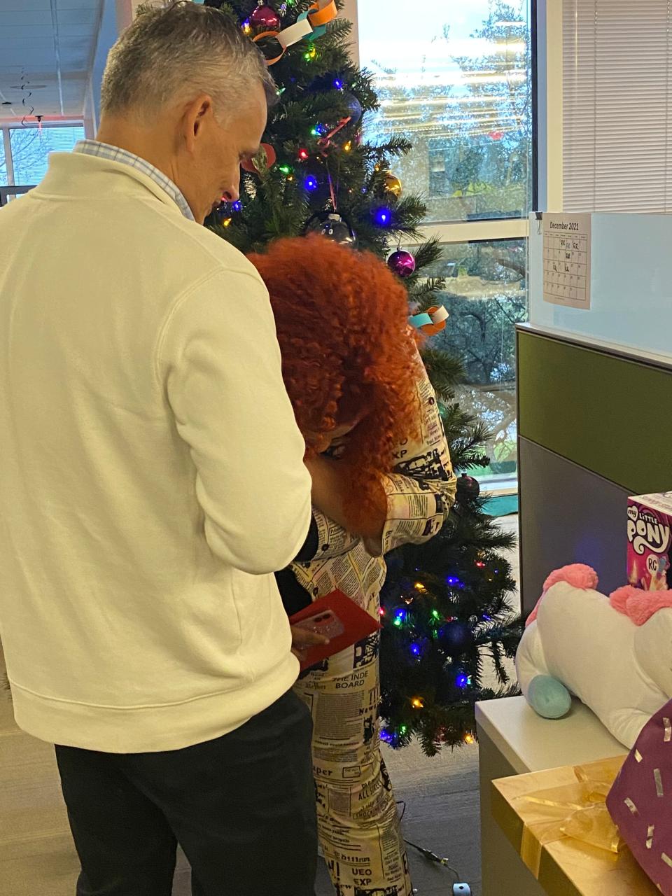 Caitlyn Coker is surprised by help from her co-workers at University Federal Credit Union. She and another co-worker were already trying to help another single mom during the holiday season.