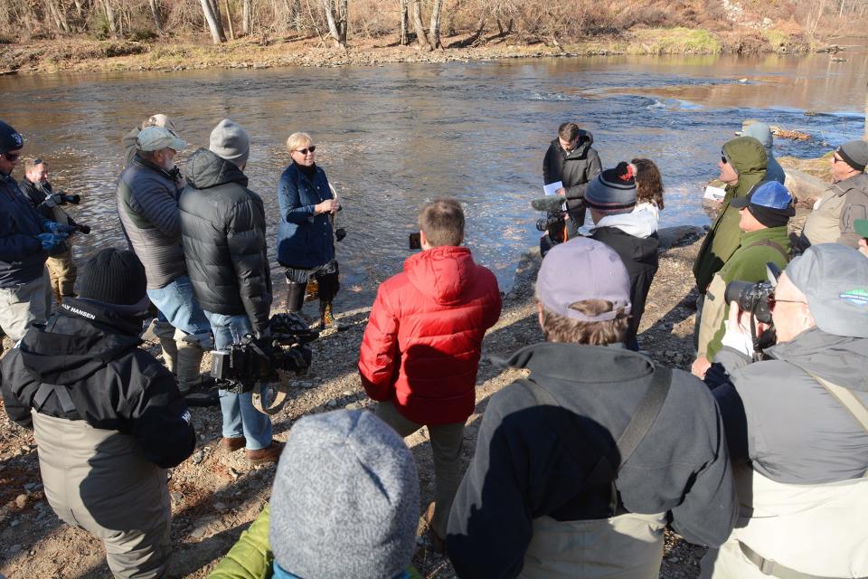 State Sen. Cathy Osten talks to fishermen before 13 Atlantic salmon are released into the Shetucket River Friday at River Park in Baltic. The Department of Energy and Environmental Protection released a total of 50 Atlantic salmon in area rivers Friday.