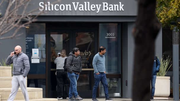 PHOTO: Employees stand outside of the shuttered Silicon Valley Bank (SVB) headquarters on March 10, 2023, in Santa Clara, Calif. (Justin Sullivan/Getty Images)