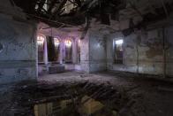 <p>Stained glass windows fill this decrepit space with a beautiful hue.</p>