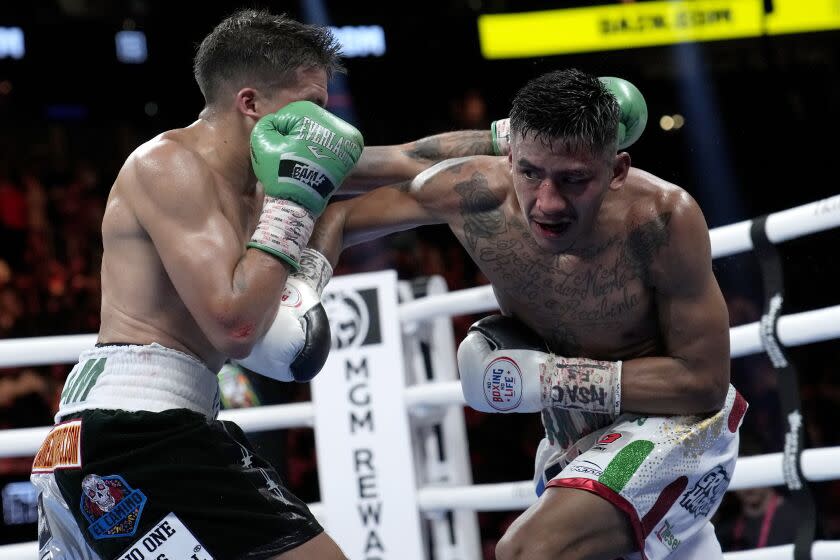 Jesse Rodriguez, left, fights Israel Gonzalez in a super flyweight title boxing match, Saturday, Sept. 17, 2022, in Las Vegas. (AP Photo/John Locher)