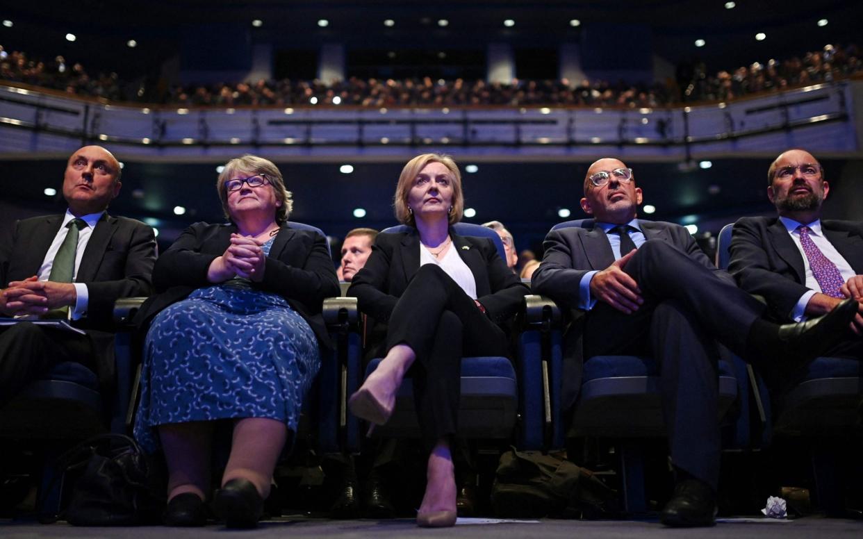 Britain's Prime Minister Liz Truss (C), flanked by from L, Britain's Financial Secretary to the Treasury Andrew Griffith, Britain's Health Secretary and deputy Prime Minister Therese Coffey, and Britain's Chancellor of the Duchy of Lancaster Nadhim Zahawi, as tthey listen to Britain's Chancellor of the Exchequer Kwasi Kwarteng (unseen) delivers his keynote address on the second day of the annual Conservative Party Conference in Birmingham, central England, on October 3, 2022 - OLI SCARFF/ AFP