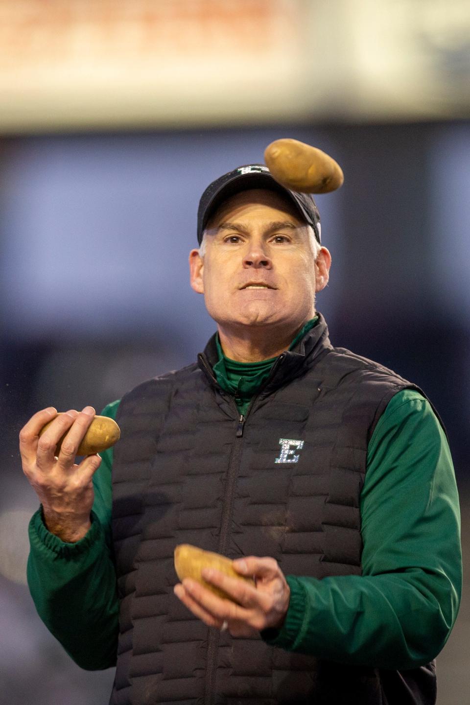 Eastern Michigan coach Chris Creighton juggles trophy potatoes during the trophy presentation after the 41-27 win over San Jose State in the Famous Idaho Potato Bowl on Tuesday, Dec. 20, 2022, in Boise, Idaho.