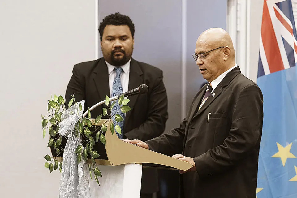 In this photo provided by the Tuvalu government, the newly elected Prime Minister, Feleti Teo, right, is sworn into office during a ceremony in Funafuti, Tuvalu, Wednesday, Feb. 28, 2024. Tuvalu's new government committed the tiny South Pacific island nation to continued diplomatic ties with Taiwan instead of switching to Beijing, but said it plans to renegotiate a security pact recently struck with Australia in response to China's growing regional influence. (Tuvalu Government via AP)