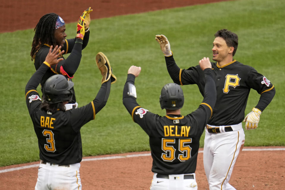 Pittsburgh Pirates' Bryan Reynolds, right, scores on an errant throw after driving in three runs with a triple off Chicago White Sox relief pitcher Jimmy Lambert during the fifth inning of a baseball game in Pittsburgh, Friday, April 7, 2023. (AP Photo/Gene J. Puskar)