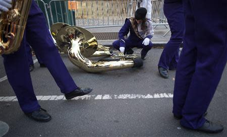 A musician adjusts her instrument before the 87th Macy's Thanksgiving day parade in New York November 28, 2013. REUTERS/Carlo Allegri