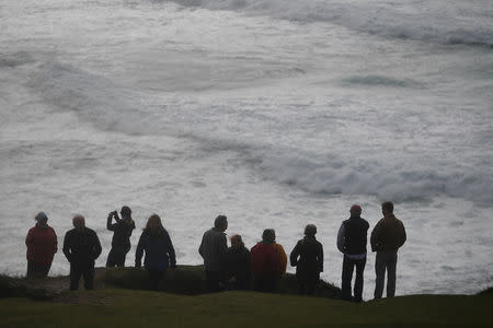 People look out at rough sea from Slea Head during Storm Ali in Coumeenoole, Ireland, September 19, 2018. REUTERS/Clodagh Kilcoyne