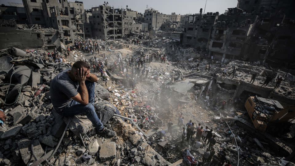 A man sits on debris as Palestinians conduct a search and rescue operation in Jabalya refugee camp in Gaza City, on November 1. - Ali Jadallah/Anadolu/Getty Images