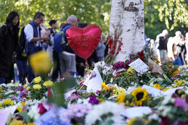 Members of the public view floral tributes in Hyde Park in London 