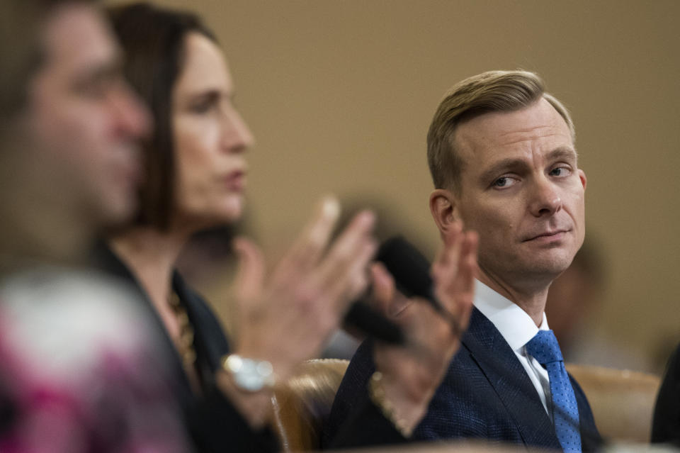 David Holmes, a U.S. diplomat in Ukraine, right, watches former White House national security aide Fiona Hill, testify before the House Intelligence Committee on Capitol Hill in Washington, Thursday, Nov. 21, 2019, during a public impeachment hearing of President Donald Trump's efforts to tie U.S. aid for Ukraine to investigations of his political opponents. (AP Photo/Manuel Balce Ceneta)