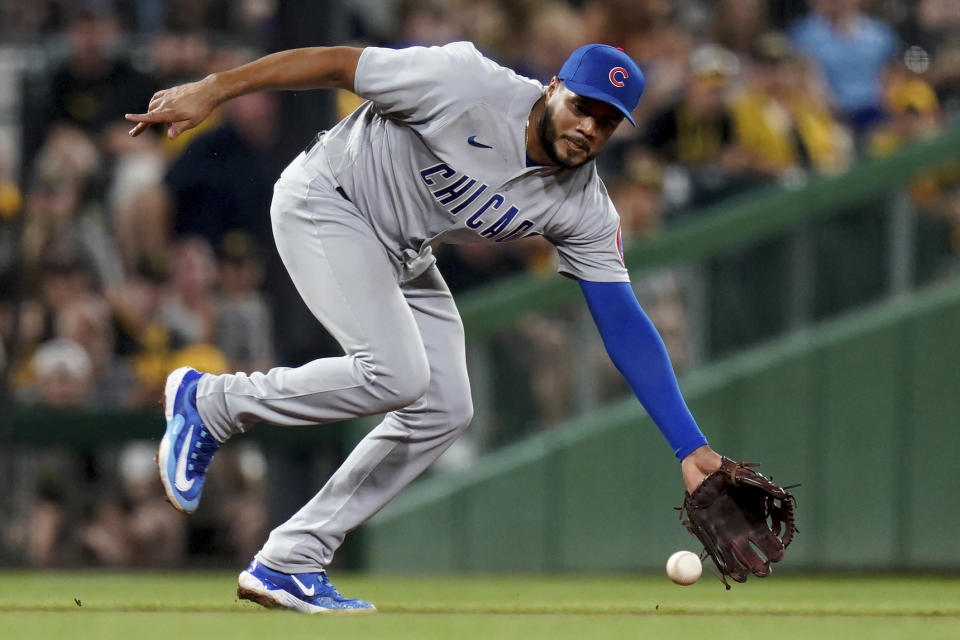 FILE - Chicago Cubs third baseman Jeimer Candelario reaches for a grounder by Pittsburgh Pirates' Endy Rodriguez, who was out at first during the fourth inning of a baseball game in Pittsburgh, Saturday, Aug. 26, 2023. Candelario has agreed to a $45 million, three-year contract with Cincinnati, giving the Reds a surplus of infielders that could lead to another move. A person familiar with the negotiations confirmed the agreement to The Associated Press on Thursday morning on condition of anonymity because it was pending a physical. The contract includes a club option that could take the value to $60 million over four years.(AP Photo/Matt Freed, File)