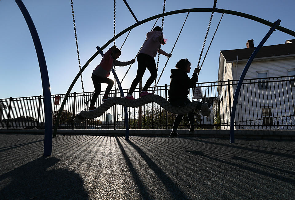 Worcester, MA - October 19: As the sun settled low in the sky, silhouettes of children playing formed at the Betty Price Playground in Worcester, MA on October 19, 2021. (Photo by Suzanne Kreiter/The Boston Globe via Getty Images)